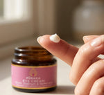 Pūraka Eye Cream on ring finger with jar in background
