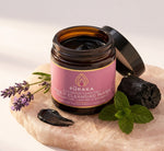 Pūraka Activated Charcoal Deep Cleansing Mask open jar with lavender, peppermint and charcoal on blush stone