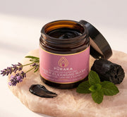 Pūraka Activated Charcoal Deep Cleansing Mask open jar with lavender, peppermint and charcoal on blush stone