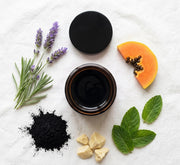 Pūraka Charcoal Mask flatlay with activated charcoal, lavender, papaya and peppermint