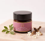Pūraka Eye Cream jar with elemi leaves, spikenard root and white flowers on blush stone