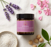 Pūraka Hydrating Face Scrub flatlay with jojoba granules, macadamia, lavender and geranium petals