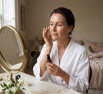 Woman applying Pūraka Hydrating Super Serum during morning skincare routine