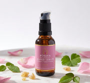 Pūraka Hydrating Super Serum with rose petals and frankincense resin on marble